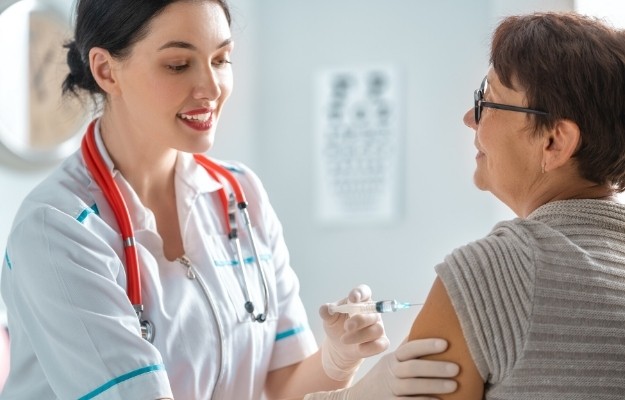 a smiling nurse injecting for an old lady | Cortisone Shots For Inflammation: Benefits And Side Effects