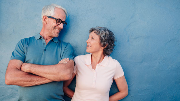 couple-comfortable-in-front-blue-wall | Are You A Candidate For IV Selenium Therapy? | Benefits of IV Selenium Treatment for Thyroid Patients